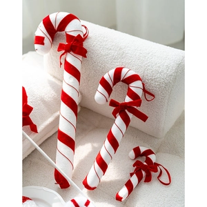 Red and white plush candy cane ornaments with velvet bows for Christmas tree decoration