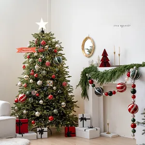 Detailed view of festive 15cm painted Christmas ball ornaments on a decorated pine tree