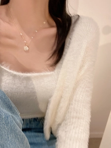 Close-up of golden pearl flower necklace on a model showing elegant design details