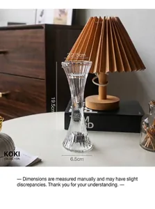 Close-up of a ribbed clear glass candlestick holder with dimensions 19.5cm height