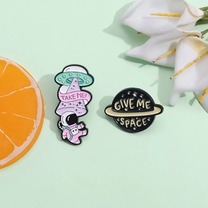 Cartoon astronaut and UFO enamel pin set with Take Me and Give Me Space slogans