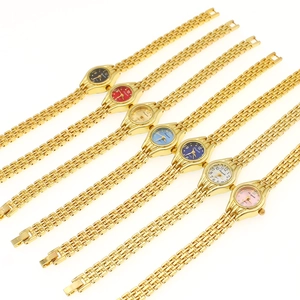 Flat lay of elegant gold quartz watches with oval cases and multi-colored dials