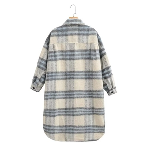 Macro shot of plaid wool coat texture showing blue and white checkered fabric details