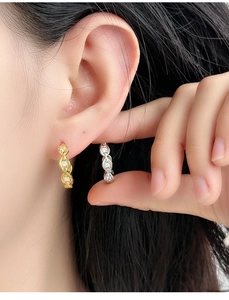 Macro close-up of S925 silver anchor chain earrings with micro-set zircon accents