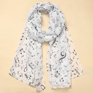 Detail of soft white chiffon scarf with elegant black musical note prints and neat edges
