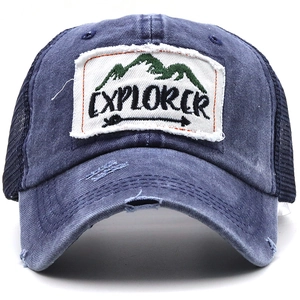 Close-up of vintage blue wash baseball cap with Explorer patch and distressed details