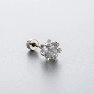 Silver star stud earring with clear zircon and screw back on a grey background