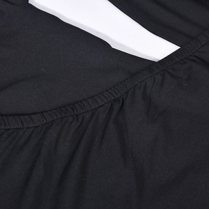 Close-up of black ruched fabric texture and stitching detail on a bodycon dress