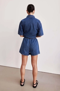 Back view of women's vintage loose denim set with short sleeve shirt and elastic shorts