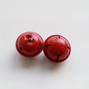 Macro shot of 4cm red matte metal bells with star and stripe cutout designs