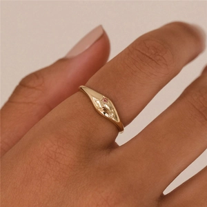 Detail of gold star signet ring with pink and clear gemstones on model finger