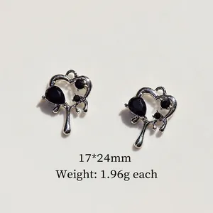 Detailed view of silver heart charms with black stones measuring 17x24mm for DIY jewelry