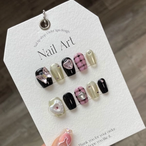 Handmade press-on nails featuring black checkered patterns and pink butterfly charms