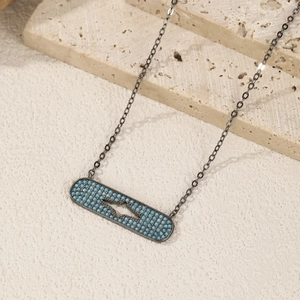 S925 sterling silver starburst necklace with turquoise pendant on travertine stone