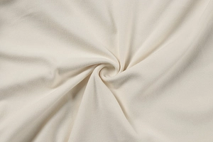 Detailed macro texture of premium cream pleated fabric with soft brushed finish