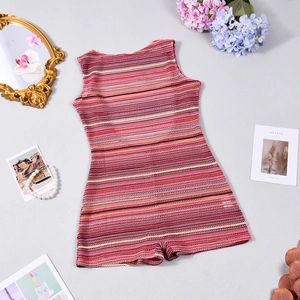 Close-up of a striped knit romper with colorful red and beige patterns on a flat lay set