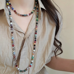 Detail of colorful faceted crystal beaded necklace on a khaki shirt model