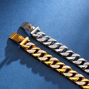 Close-up of gold and silver cuban link bracelets with sparkling pave-set stones