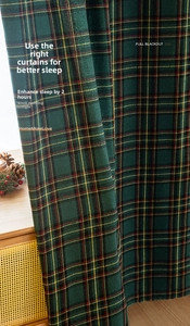 Detail of red and green plaid festive curtains featuring full blackout fabric and soft texture