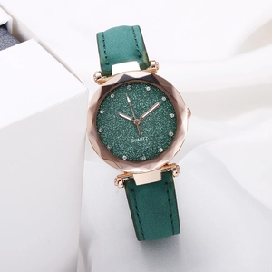 Detail of starry green dial with crystal markers and rose gold faceted watch case