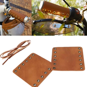 Brown vintage leather motorcycle grips with removable lace-up covers and matching straps