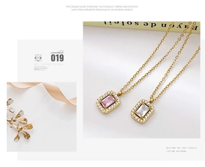 Detail of gold chain necklace with rectangular pink and white zircon stone pendants