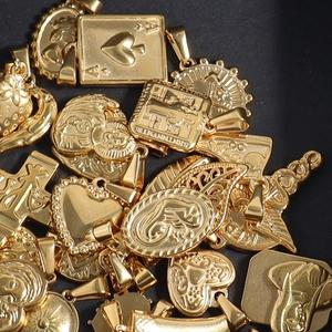 Collection of 24K gold plated stainless steel pendants featuring heart and portrait designs