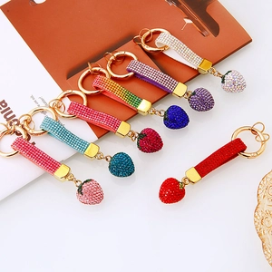 Sparkling rhinestone strawberry keychains in multiple vibrant colors with gold metal rings