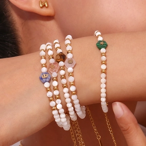 Stacked stainless steel beaded bracelet set with white shell pearls and colorful stones