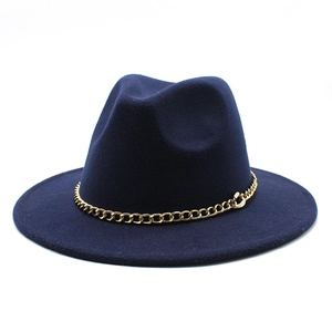 Detailed view of dark blue wool fedora with a decorative chunky gold chain accent