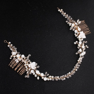 Handmade bridal hair comb with white ceramic flowers, pearls, and crystals on gold wire