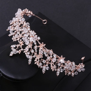 Detailed view of rose gold bridal crown with crystal flower and vine motifs