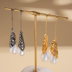 18k gold plated drop earrings with metallic mesh and white pearls on a display stand