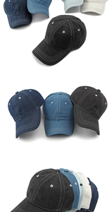 Detailed view of washed denim baseball caps with contrast stitching and metal eyelets