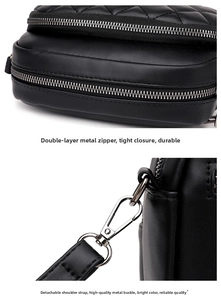 Detail of black quilted leather bag with dual silver zippers and removable strap buckles