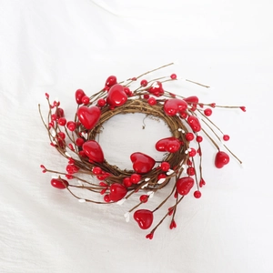 Macro shot of 30cm heart wreath with red berries and natural vine for Valentine's Day decor