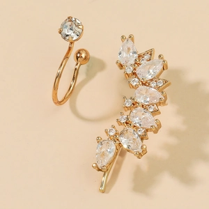 Detailed shot of golden earring set with sparkling pear-cut and round zircon crystals