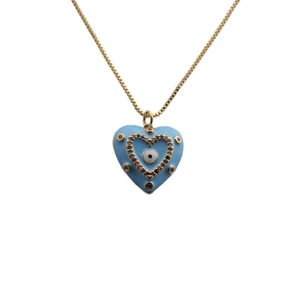 Detailed close-up of golden heart pendant with blue enamel evil eye and sparkling crystals