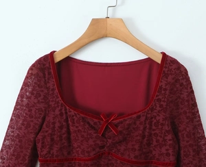 Detail of square neckline with velvet trim and bow on burgundy floral lace dress