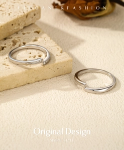 Detail of S925 sterling silver minimalist rings with cubic zirconia on stone texture