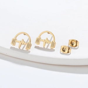 Macro shot of gold headphone shaped earrings with heartbeat wave design on white pedestal