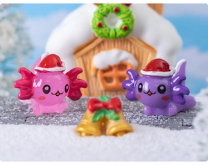 Macro shot of pink and purple Christmas axolotl resin figurines with festive hats