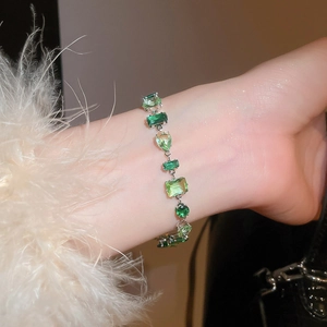 Close-up of sparkling green cubic zirconia bracelet in teardrop and square shapes