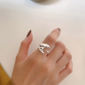 Macro shot of liquid lava style irregular S925 silver open ring on model hand