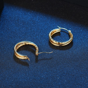 Classic gold double hoop earrings with textured outer layer and polished inner rings