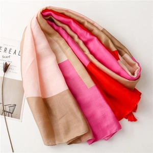 Detail of multi-color cotton scarf with soft tassels and minimalist fabric texture