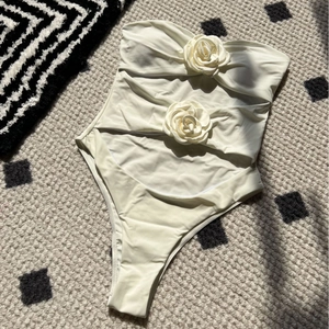 White cut-out one-piece swimsuit with 3D rose floral accents and bandeau neckline style