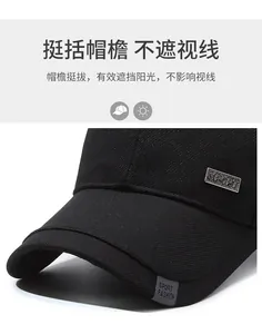 Detail of black cotton baseball cap showing metal Sport plaque and woven brim label