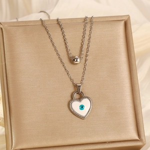 Silver double layer necklace with beaded chain and white enamel evil eye heart pendant