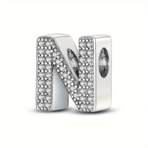 Macro view of silver charm bead letter N with sparkling cubic zirconia pave setting